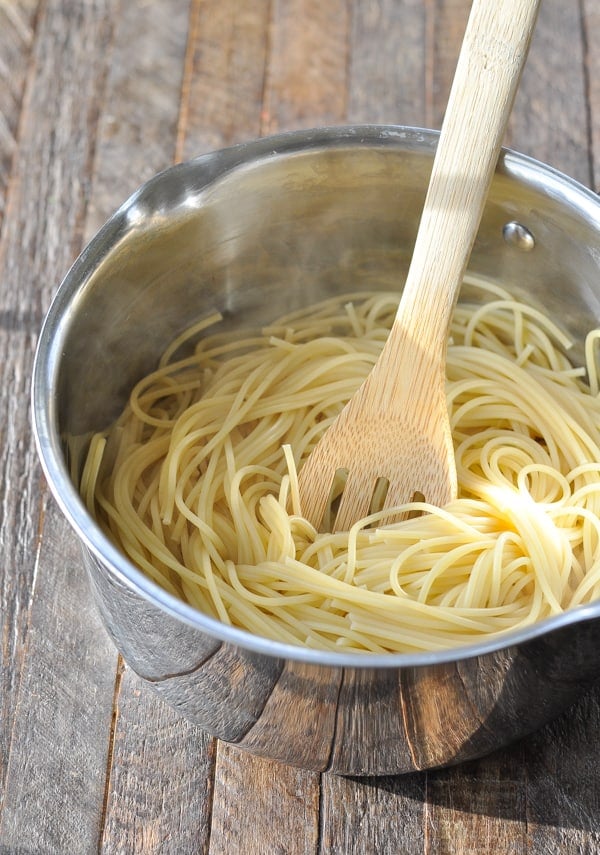 Cook spaghetti noodles in a pot