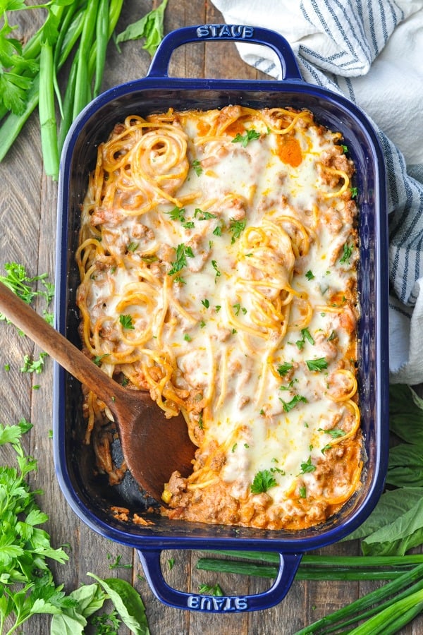 Overhead shot of baked spaghetti casserole in a blue dish