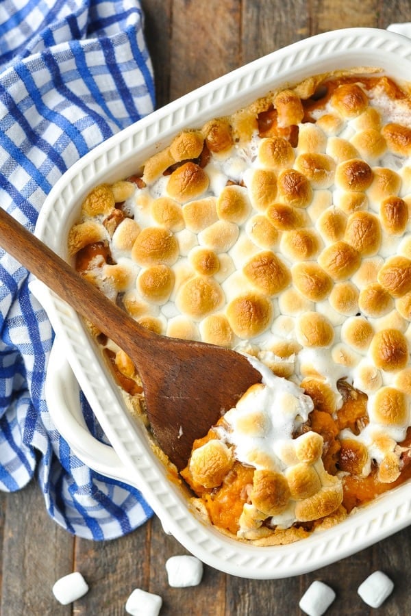 Overhead shot of sweet potato casserole with marshmallows and pecans in a white baking dish