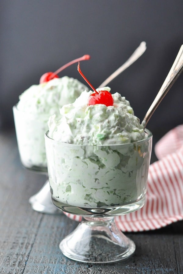 Two bowls of watergate salad with cherries on top