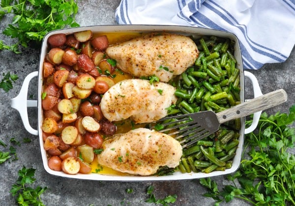 Overhead horizontal shot of baked chicken and potatoes with green beans