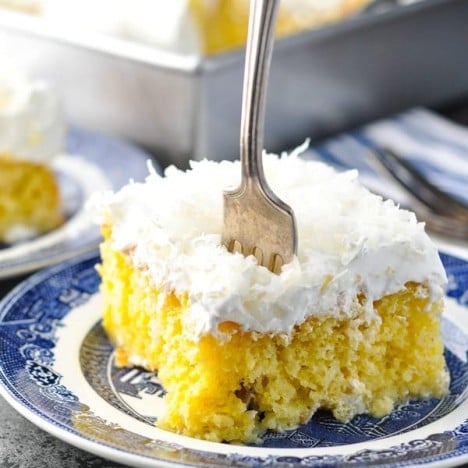 Fork digging into a slice of easy moist coconut cream cake