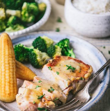 Broccoli and cornbread on a plate with the best crock pot ranch pork chop recipe