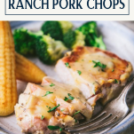 Close up side shot of a plate of sliced crock pot ranch pork chops with text title box at top
