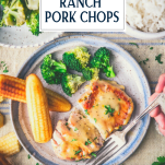 Overhead shot of hands eating a plate of slow cooker ranch pork chops with text title overlay