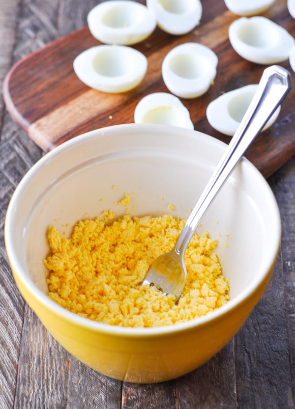 Mashing egg yolks for deviled eggs