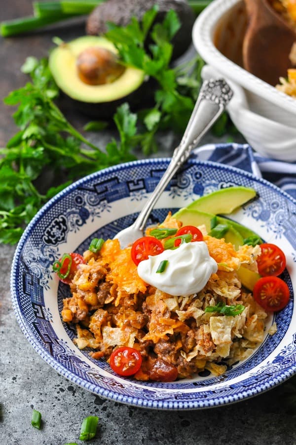 Front shot of a fork in a bowl of nacho casserole