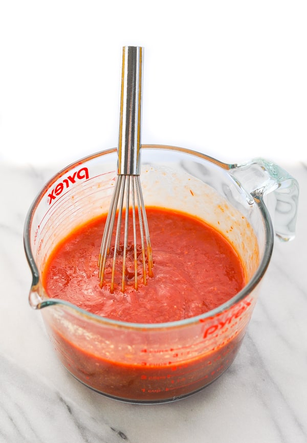 Homemade cocktail sauce in glass measuring cup