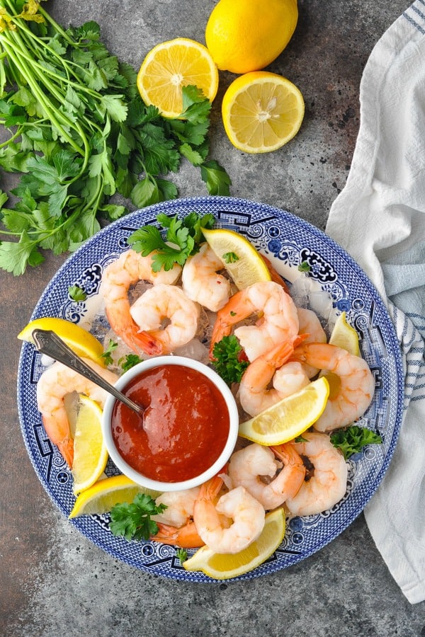 Overhead shot of a plate of shrimp cocktail with sauce