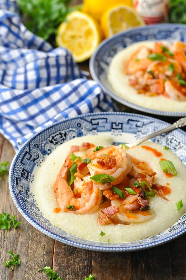 Front shot of a southern shrimp and grits recipe in a blue and white bowl