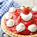 Front shot of strawberry pie with whipped cream on top
