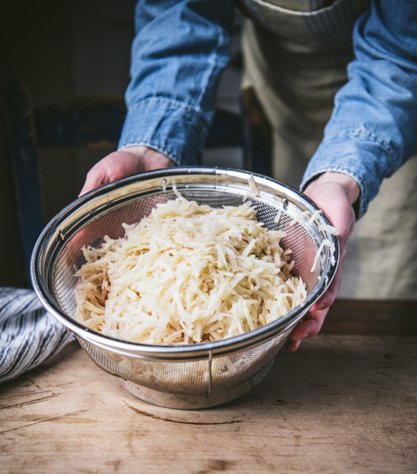 Shredded potatoes in a colander