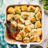 Square overhead image of a white dish full of sloppy joe biscuit casserole.