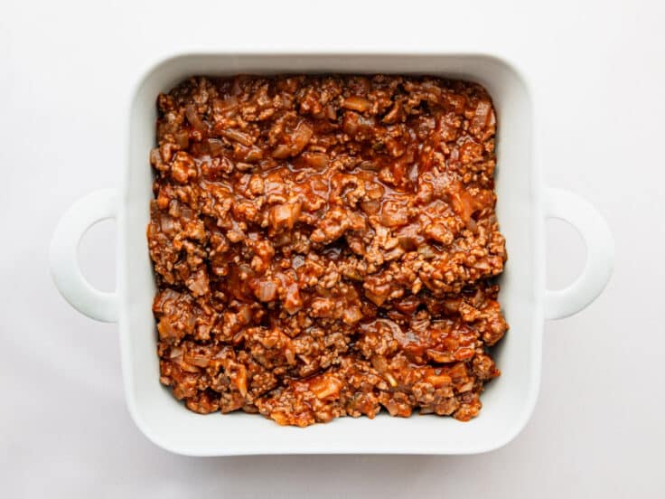 Sloppy joe filling in a white baking dish.