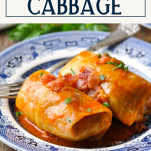 Close up side shot of stuffed cabbage rolls on a plate with text title box at top