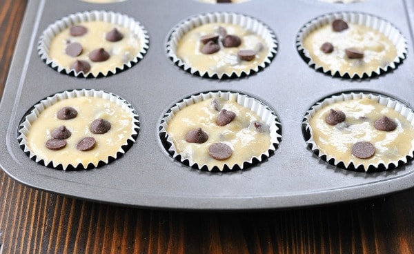 Banana chocolate chip muffin batter in muffin cups before baking