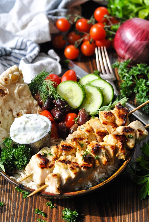 Chicken souvlaki served in a bowl with rice and tzatziki sauce
