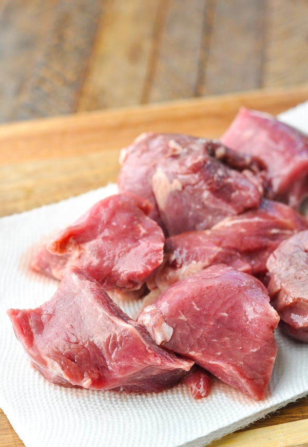 Raw steak tips on a cutting board