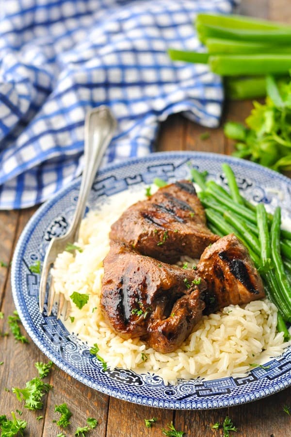 Plate of grilled steak tips served with rice and green beans