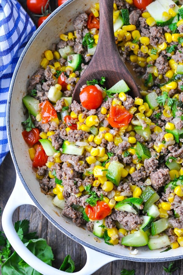 Close overhead shot of a skillet full of ground beef corn and zucchini