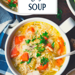Close overhead shot of a bowl of lemon chicken and orzo soup with text title overlay