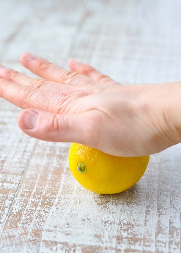 Rolling fresh lemon before juicing