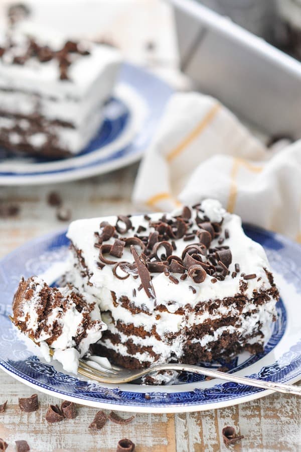 Piece of old fashioned icebox cake on a plate with a bite on a fork