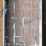 Process shot of layering chocolate graham crackers for icebox cake