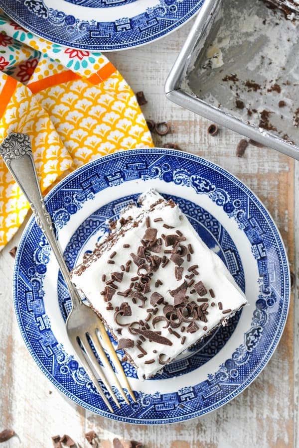 Overhead shot of a slice of chocolate icebox cake on a blue and white plate