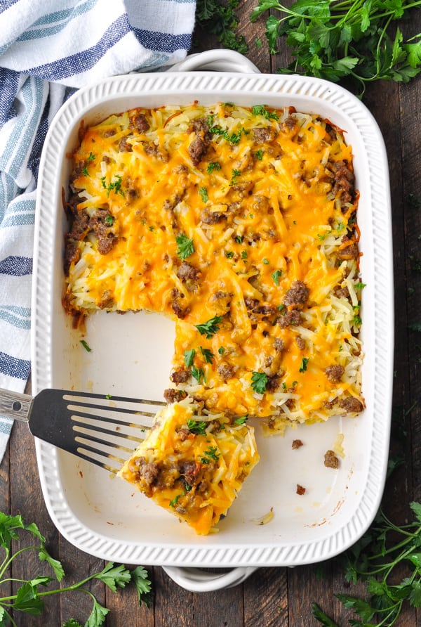 Overhead shot of hash brown casserole with sausage in a white baking dish