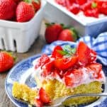 Fresh strawberry shortcake cake garnished with mint leaves on a serving plate