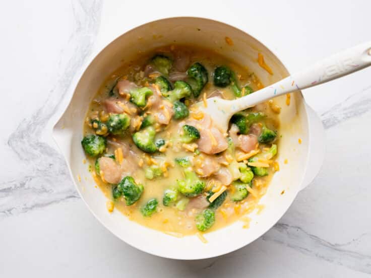 Stirring together the filling ingredients in a mixing bowl.