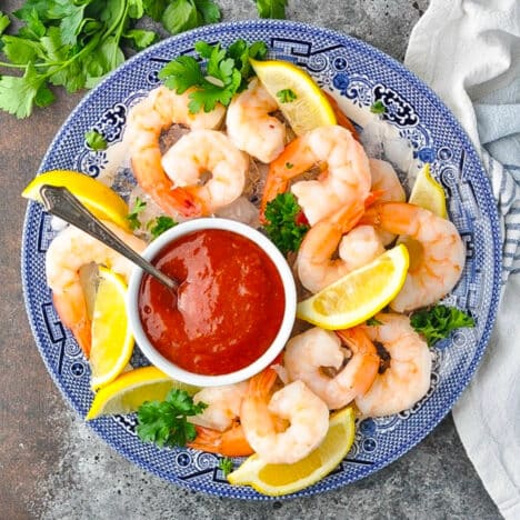 Square overhead shot of shrimp cocktail on a plate.