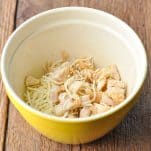 Cooked chicken with cheese in a bowl