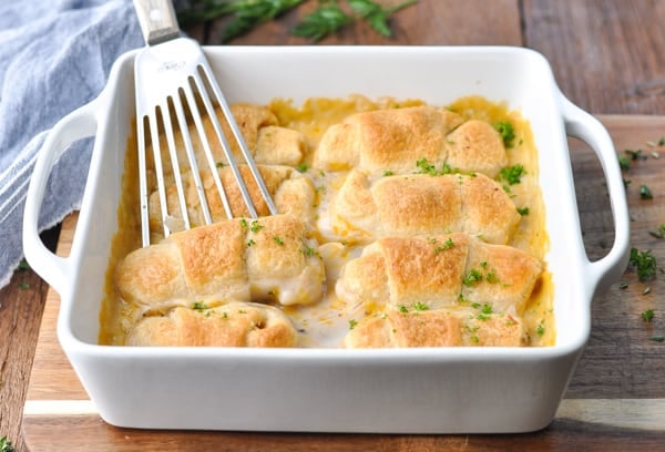 Horizontal shot of cheesy chicken crescent rolls in a white dish