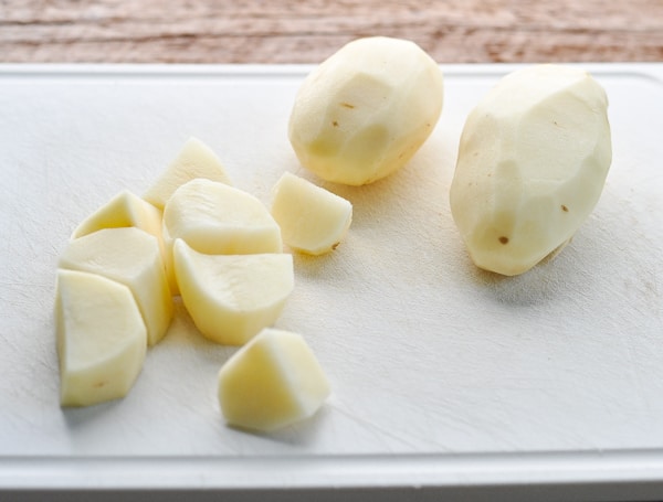 Russet potatoes on a cutting board