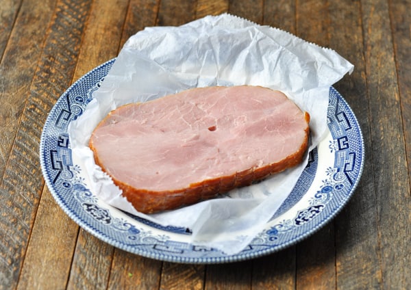 Ham steak on a plate before cooking