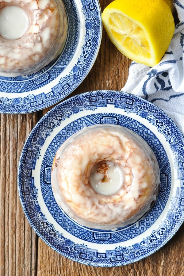 Overhead shot of a lemon baked donut on a blue and white plate