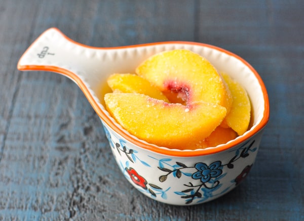 Frozen peaches in a measuring cup