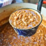 Ladle full of ranch style beans from a dutch oven