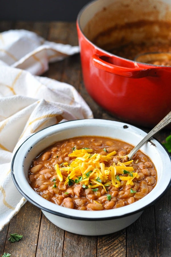 Front shot of a spoon in a bowl full of homemade ranch style beans