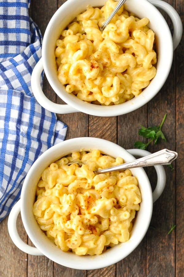 Overhead shot of two bowls of stovetop mac and cheese on a wooden table