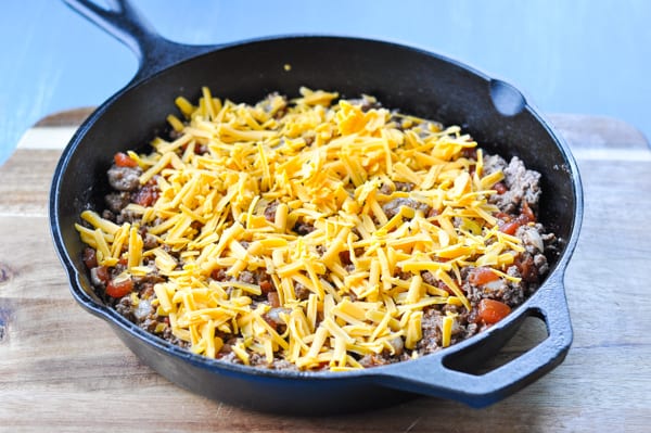 Process shot of making tamale pie in a cast iron skillet