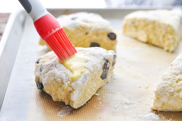 Brushing top of scones with egg wash before baking