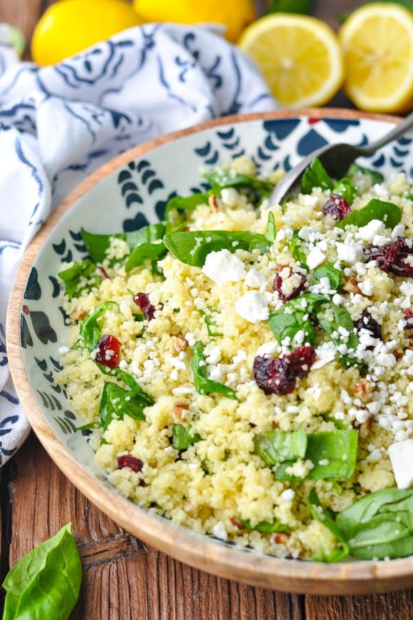 Close up front shot of a bowl of couscous salad with cranberries