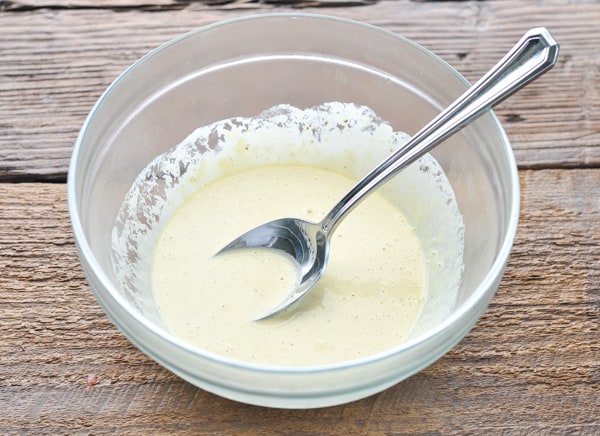 Mayonnaise mixture for crab imperial in a glass mixing bowl