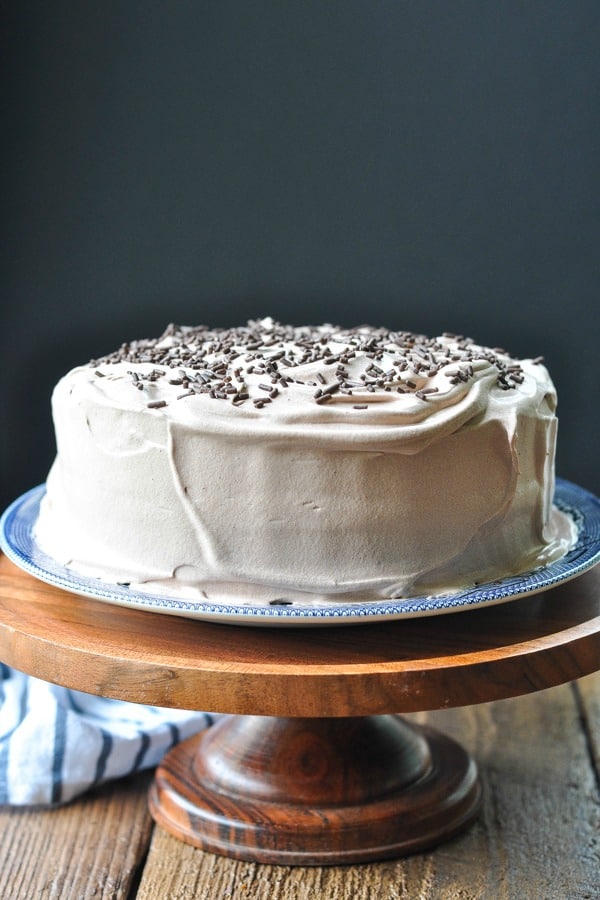 Front shot of an easy chocolate cake on a wooden cake stand