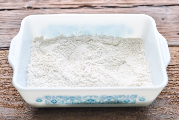 Shallow dish of seasoned flour for dredging fried chicken