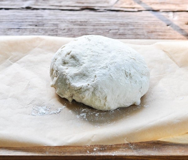 Forming loaf of no knead bread on a piece of parchment