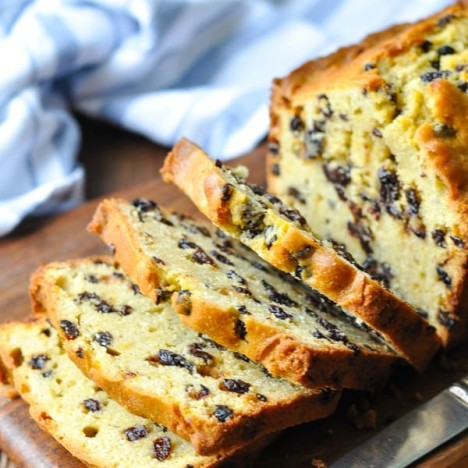 Slices of Colonial Williamsburg Queen's Cake on a cutting board with blue and white striped towel